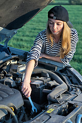 Image showing Young Blond Woman With Her Broken Car