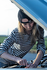 Image showing Young Blond Woman With Her Broken Car