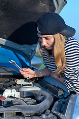 Image showing Young Blond Woman With Her Broken Car