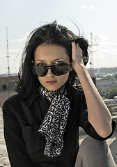 Image showing Young woman on roof