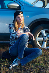 Image showing Young Blond Woman With Her Broken Car