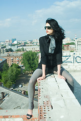 Image showing Young woman on roof