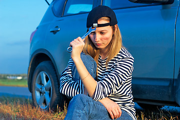 Image showing Young Blond Woman With Her Broken Car