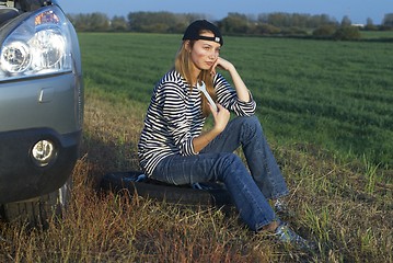 Image showing Young Blond Woman With Her Broken Car