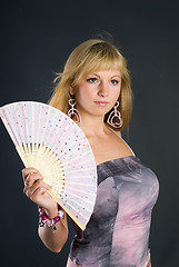 Image showing Beautiful young woman with fan