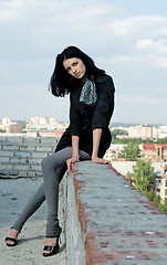 Image showing Young woman on roof