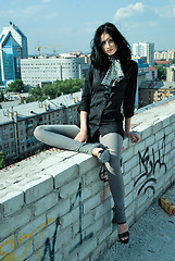 Image showing Young woman on roof