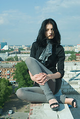 Image showing Young woman on roof