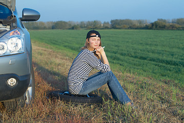 Image showing Young Blond Woman With Her Broken Car