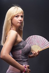 Image showing Beautiful young woman with fan