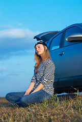 Image showing Young Blond Woman With Her Broken Car