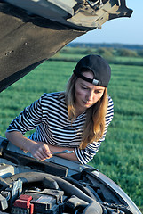 Image showing Young Blond Woman With Her Broken Car