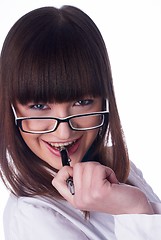 Image showing Girl biting pen