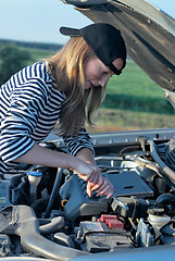 Image showing Young Blond Woman With Her Broken Car