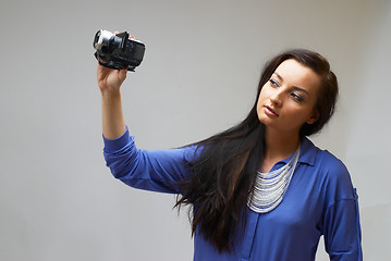 Image showing Young woman with camera