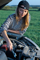 Image showing Young Blond Woman With Her Broken Car