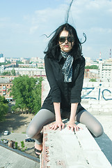 Image showing Young woman on roof