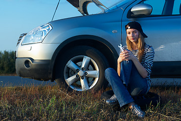 Image showing Young Blond Woman With Her Broken Car