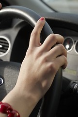 Image showing Girl hand on wheel steering