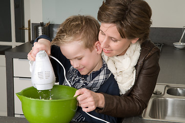 Image showing Mother and son mixing the dough