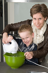 Image showing Mother and son mixing the dough