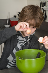 Image showing Boy making the dough for the cakes