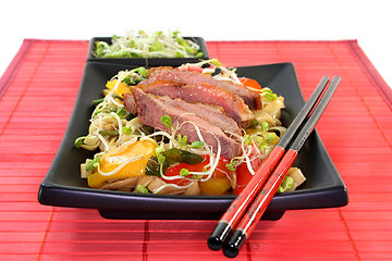 Image showing Duck breast with fried noodles