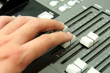 Image showing Closeup of audio mixing console. Shallow depth of field. Studio 