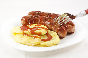 Image showing Eating sausages