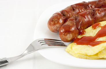 Image showing Sausages and fried potaoes