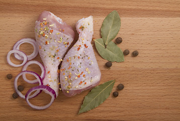 Image showing raw chicken meat with herbs, onions and peppers