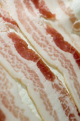 Image showing raw bacon strips on paper towel selective focus for microwave