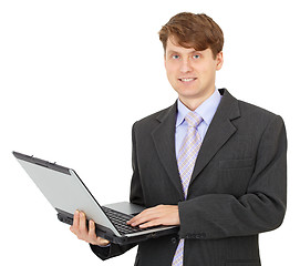 Image showing Young businessman with computer in hands