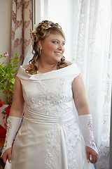 Image showing Bride at window waiting for groom