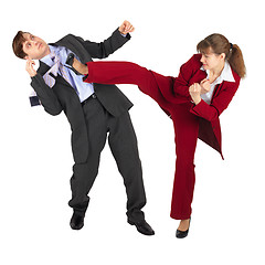 Image showing Young woman kicks man in business suit