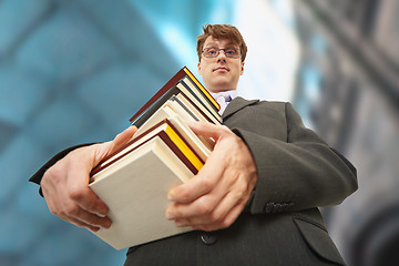 Image showing Librarian holding pile of books