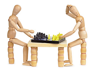 Image showing Two silly wooden men play chess