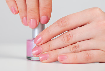 Image showing Hands hold a vial - nail polish