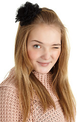 Image showing Playful young girl winks on white background