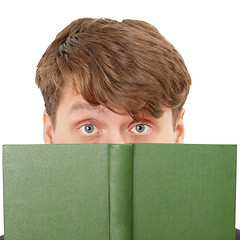Image showing Young man hid his face behind a green book