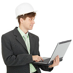 Image showing Smiling engineer in helmet with laptop in hands