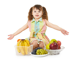 Image showing Little girl with big heap of different fruits