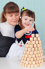 Image showing Mom and daughter play - to build a tower