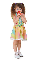 Image showing Sad little girl to eat apple on white background