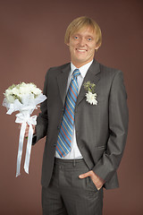 Image showing Happily smiling groom with bunch