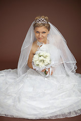 Image showing Bride in white dress sits on brown background