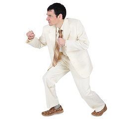 Image showing Aggressive businessman, willing to attack on white