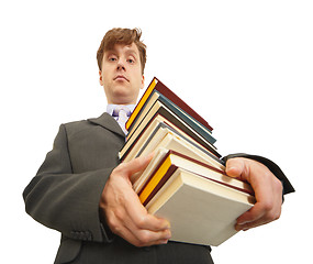 Image showing Waggish man holding pile of textbooks