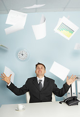 Image showing Bureaucrat -  businessman juggling documents