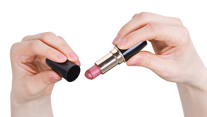 Image showing Female hands on hold lipstick